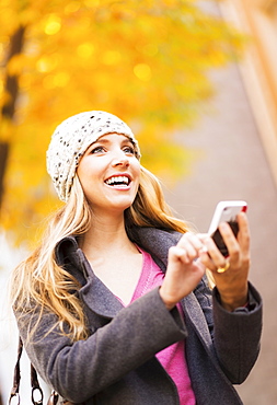 Portrait of blond woman using cell phone, USA, New York City, Brooklyn, Williamsburg