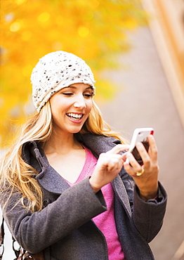 Portrait of blond woman using cell phone, USA, New York City, Brooklyn, Williamsburg