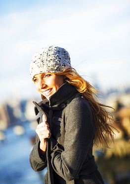 Portrait of cheerful woman in overcoat in autumn, USA, New York City, Brooklyn, Williamsburg