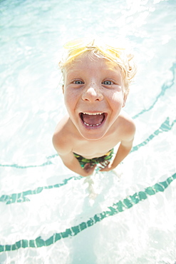 Boy (4-5) posing in swimming pool