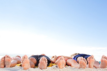 Two couples lying on their backs soaking up the sun