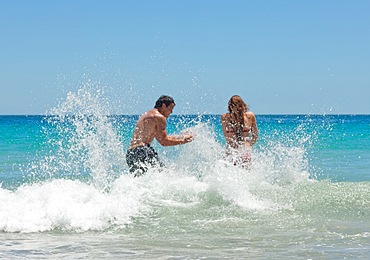 Lovers playing in the sea