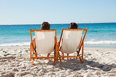 Rear view of a couple in deck chair