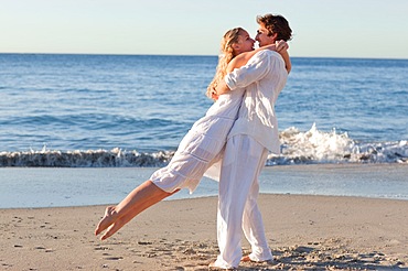 Couple spinning at the beach during sunset