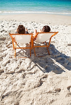 Rear view of a couple in folding chair