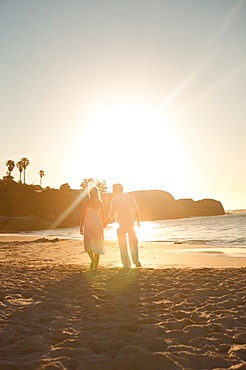 Sunset with a couple walking on the beach