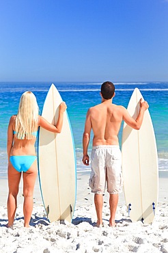 Couple with their surfboards