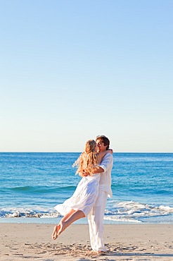 Couple turning at the beach