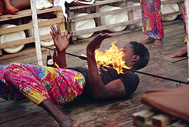 Young man limbo dancing, Kenya, East Africa, Africa