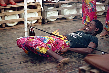 Young man limbo dancing, Kenya, East Africa, Africa