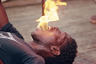 Young man fire eating, Kenya, East Africa, Africa