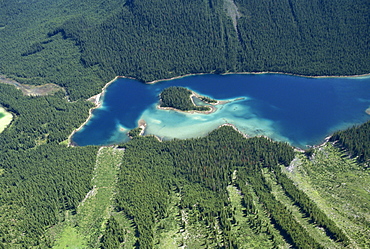 Lake in Rocky Mountains near Banff, with avalanche damage visible in bottom half of picture, Alberta, Canada, North America