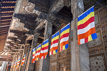 Colourful Buddhist flags adorning columns, Temple of the Sacred Tooth Relic, UNESCO World Heritage Site, Kandy, Sri Lanka, Asia 