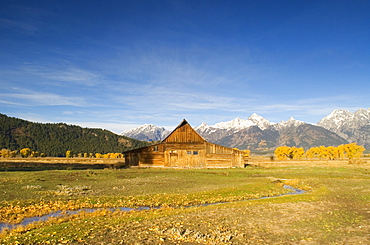 Traditional agricultural barn and the Teton Mountain range at dawn, Wyoming, USA