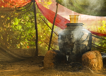 Boiling water for washing, Gokarna, Karnataka, India