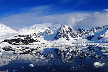 Perfect reflection of snow capped mountains, Paradise Bay Peninsula, Antarctica,Southern Ocean.