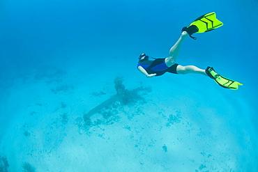 Freediver and WWII plane wreck.  Yap, Federated States of Micronesia, Pacific Ocean.  More info:  This is the tail of a Japanese bomber shot down over Yap during the summer of 1944 by U.S. planes.