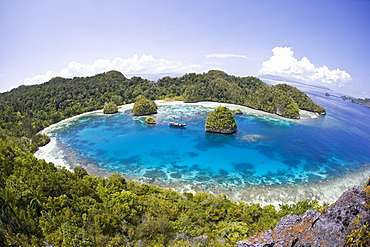 Liveaboard dive boat at remote anchorage.  Raja Ampat, Papua, Indonesia, Pacific Ocean.