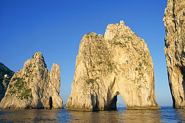 Rock arches known as the Faraglioni Stacks off the coast of the island of Capri, Campania, Italy, Europe