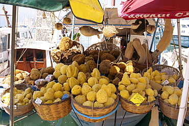 Sponges for sale on a stall on the quayside on the island of Rhodes, Dodecanese, Greek Islands, Greece, Europe