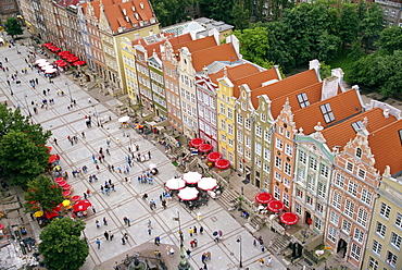 Aerial view of the bright postwar renovation of the houses of Dlugi Targ, with cafe umbrellas on the street, in the city of Gdansk, Pomerania, Poland, Europe