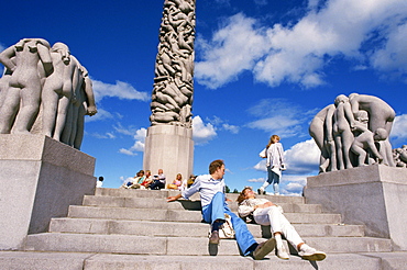 People relaxing on steps before sculptures on the central stele in Frogner Park (Vigeland's Park), Oslo, Norway, Scandinavia, Europe