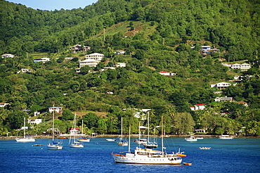 Houses overlooking bay with moored sailing boats, Bequia Island, the Grenadines, Windward Islands, West Indies, Caribbean, Central America