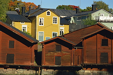 Typical heavy red of fishermen's cottages and sheds lining the River Porvoo, Porvoo (Borga), Finland, Scandinavia, Europe