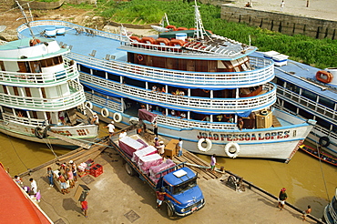 River boats on the quayside being unloaded at Parintins in the Amazon area of Brazil, South America