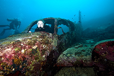 Diver inside the wreck of a four seater airplane, Philippines, Southeast Asia, Asia