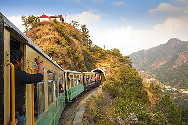 The Himalayan Queen toy train approaching a tunnel, on the Kalka to Shimla Railway, UNESCO World Heritage Site, Northwest India, Asia