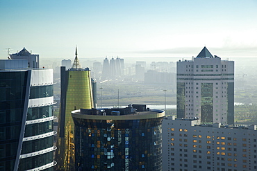 View of city looking towards twin golden conical business centre and House of Ministries, Astana, Kazakhstan, Central Asia, Asia