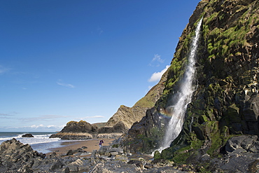 Waterfall cascading over a sea cliff at Tresaith, Ceredigion, West Wales, United Kingdom, Europe