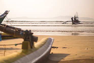 Weligama Beach, a fishing boat returning from sea on the South Coast of Sri Lanka, Indian Ocean, Asia