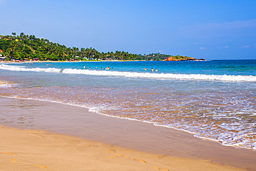 Golden sands and blue waters of the Indian Ocean at Mirissa Beach, South Coast, Sri Lanka, Asia 