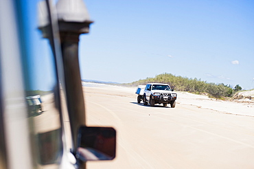 Tourists driving on Seventy Five Mile Beach on a self drive 4x4 tour of Fraser Island, UNESCO World Heritage Site, Queensland, Australia, Pacific