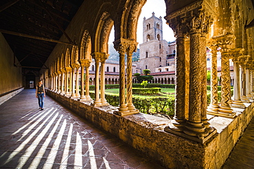 Tourist at Duomo di Monreale (Monreale Cathedral) in the courtyard gardens, Monreale, near Palermo, Sicily, Italy, Europe