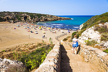 Tourist walking down the steps to Calamosche Beach, near Noto, Vendicari Nature Reserve, South East Sicily, Italy, Mediterranean, Europe 