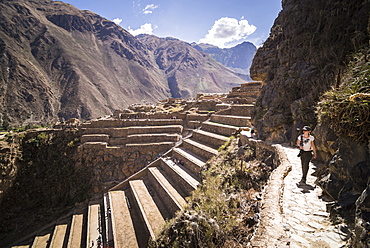 Woman exploring Inca Ruins of Ollantaytambo, Sacred Valley of the Incas (Urubamba Valley), near Cusco, Peru, South America