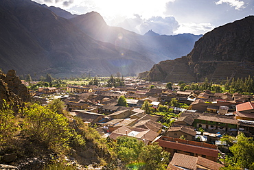 Ollantaytambo Inca Ruins at sunset seen behind Ollantaytambo Town, Sacred Valley of the Incas, near Cusco, Peru, South America