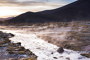 Geothermal river at sunrise at Chalviri Salt Flats (Salar de Chalviri), Altiplano of Bolivia, South America