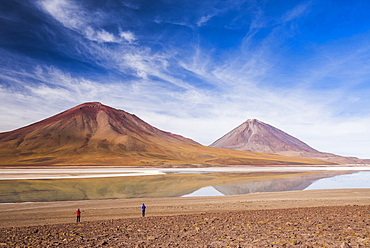 Tourists at Licancabur volcano on right and Laguna Verde, Bolivia near the border with Chile, Bolivia, South America