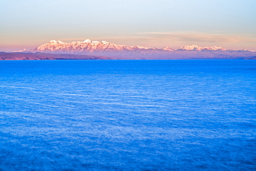 Cordillera Real Mountain Range, part of Andes Mountains, and Lake Titicaca at sunset, seen from Isla del Sol, Bolivia, South America