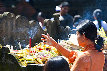 Balinese woman praying with incense at Pura Tirta Empul Hindu Temple, Bali, Indonesia, Southeast Asia, Asia