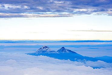 Volcanoes of Illiniza Norte, 5126m on left and Illiniza Sur, 5248m on right, seen from Cotopaxi Volcano 5897m summit, Cotopaxi Province, Ecuador, South America