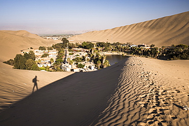 Climbing sand dunes at sunset at Huacachina, a village in the desert, Ica Region, Peru, South America