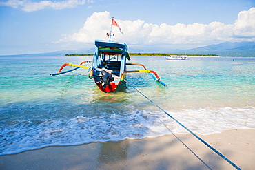 Gili Meno, a traditional Indonesian boat on Gili Meno with Gili Air and Lombok in the background, Gili Islands, Indonesia, Southeast Asia, Asia