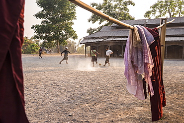 Novice monks playing football at a Buddhist Monastery between Inle Lake and Kalaw, Shan State, Myanmar (Burma), Asia