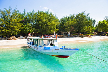 Traditional Indonesian boats in the crystal clear sea of Gili Trawangan, Gili Islands, Indonesia, Southeast Asia, Asia