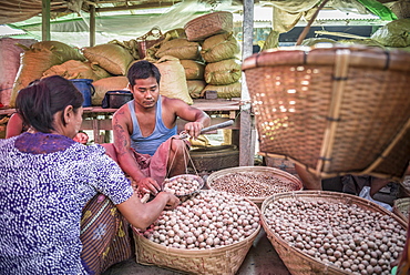 Weighing potatoes in Mrauk U vegetable market, Rakhine State, Myanmar (Burma), Asia